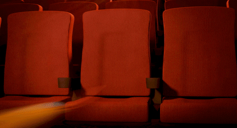 Desenho animado de uma ave assistindo filme no cinema.
